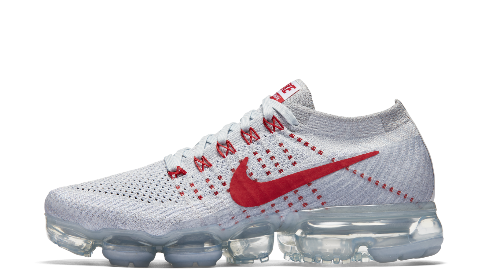 First-generation Nike Air VaporMax with a platinum Flyknit upper, red Swoosh and transparent Air cushioning. Official Nike launch photograph.