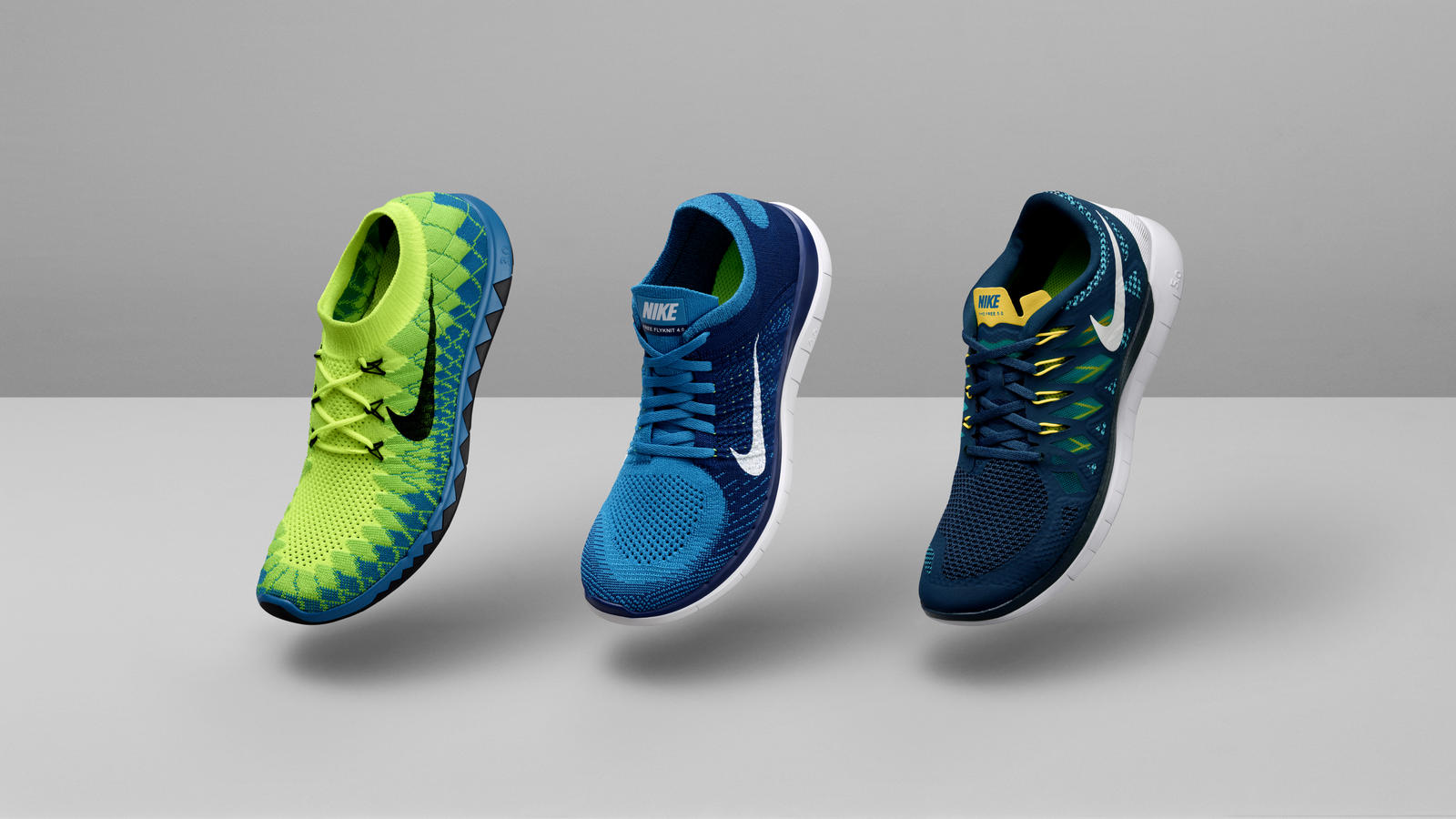 Official 2014 Nike Free men’s lineup: green 3.0 Flyknit, blue 4.0 Flyknit and navy 5.0, left to right, against a gray studio background.