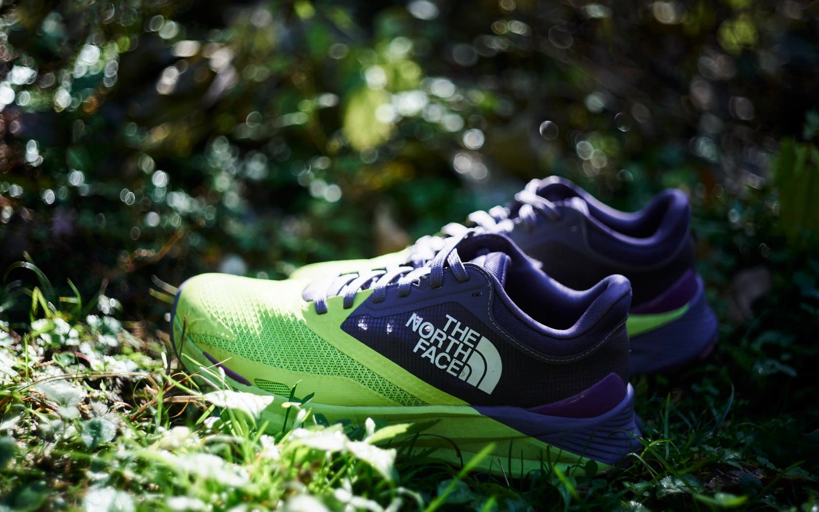 Purple and fluorescent yellow VECTIV Enduris III pair on the forest floor.