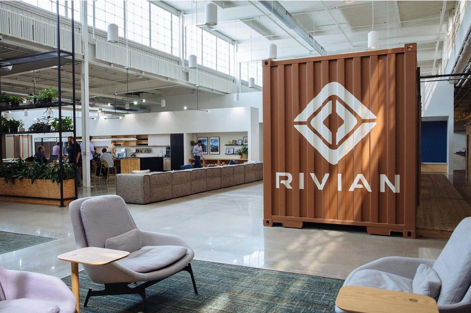 Rivian workspace with an orange shipping container carrying the company identity.