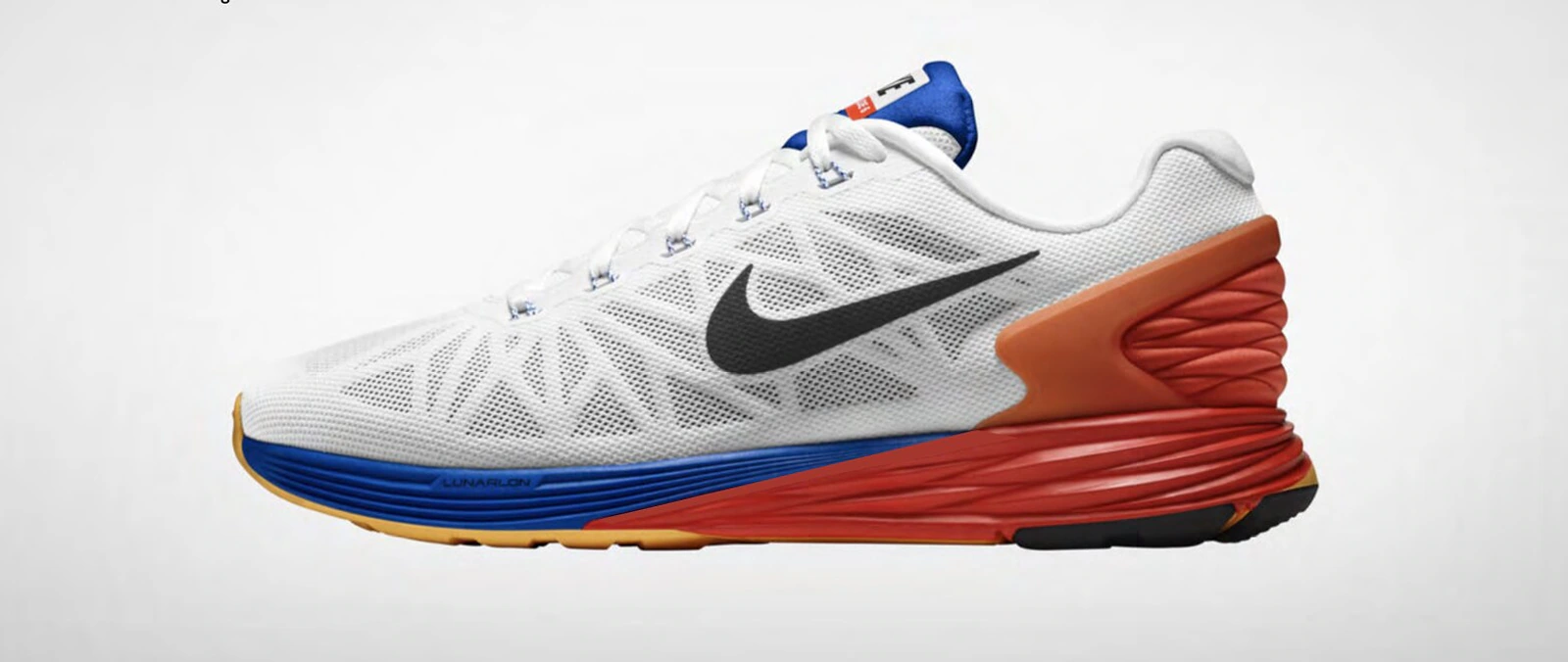 Nike Running shoe in white mesh with blue, red and orange sculpted cushioning.