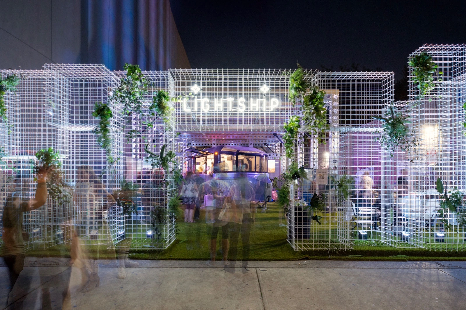 Lightship SXSW 2023 brand launch environment at night with a white modular grid, planting and the L1 prototype.