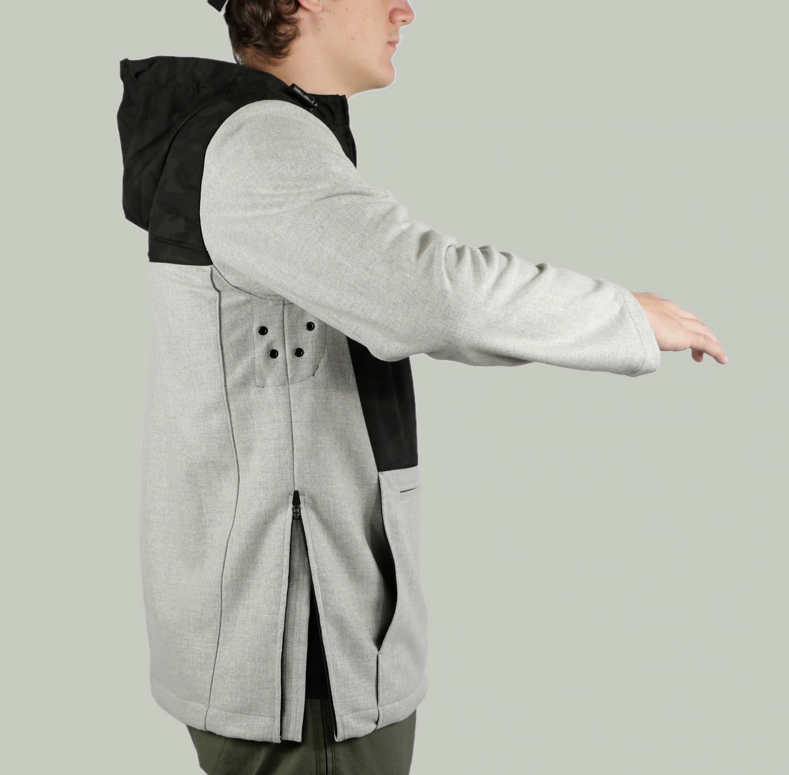 Side view of a model wearing the Terrascout grey and black anorak.