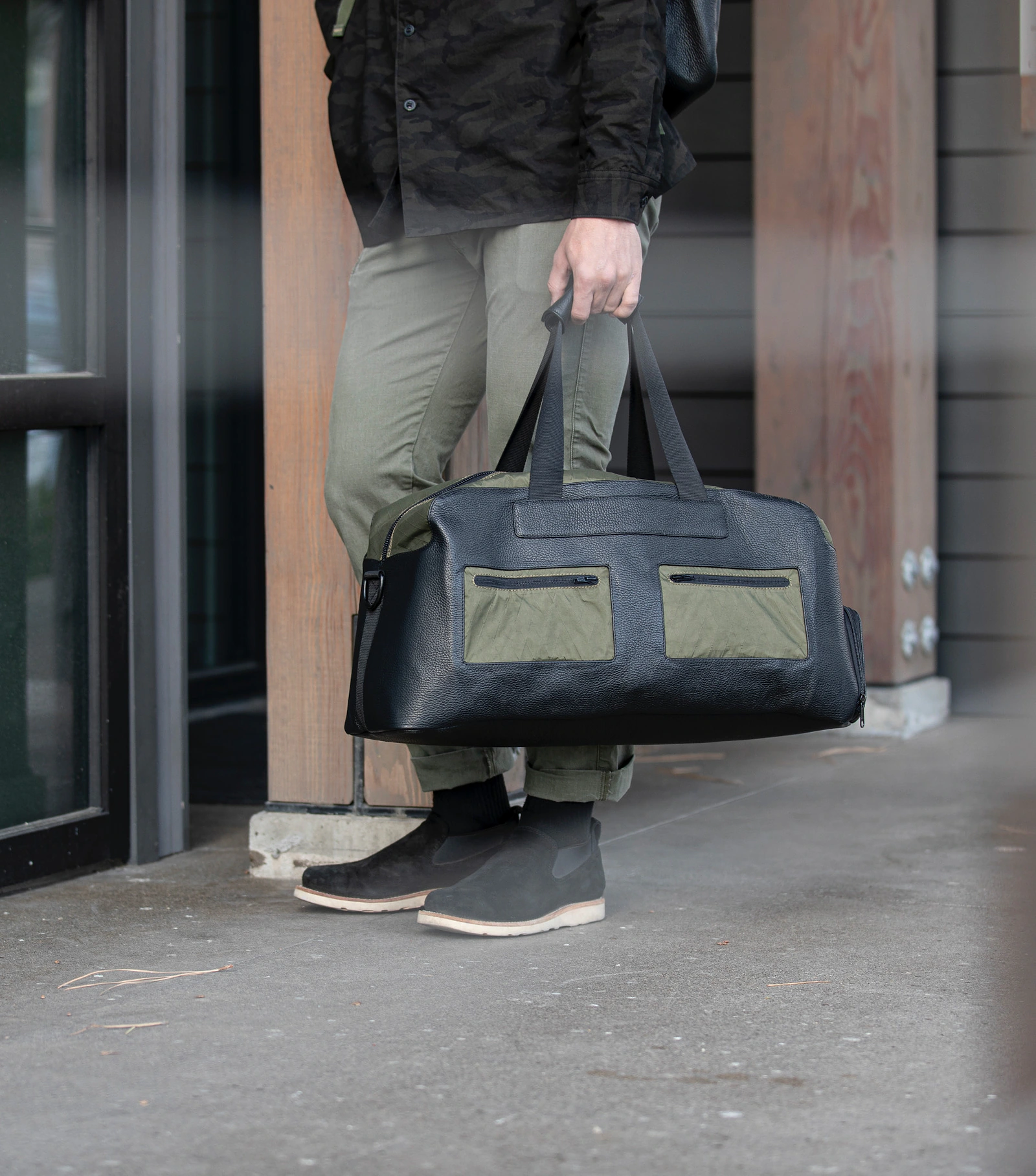 Close product-in-use view of the Terrascout black and olive duffel bag.
