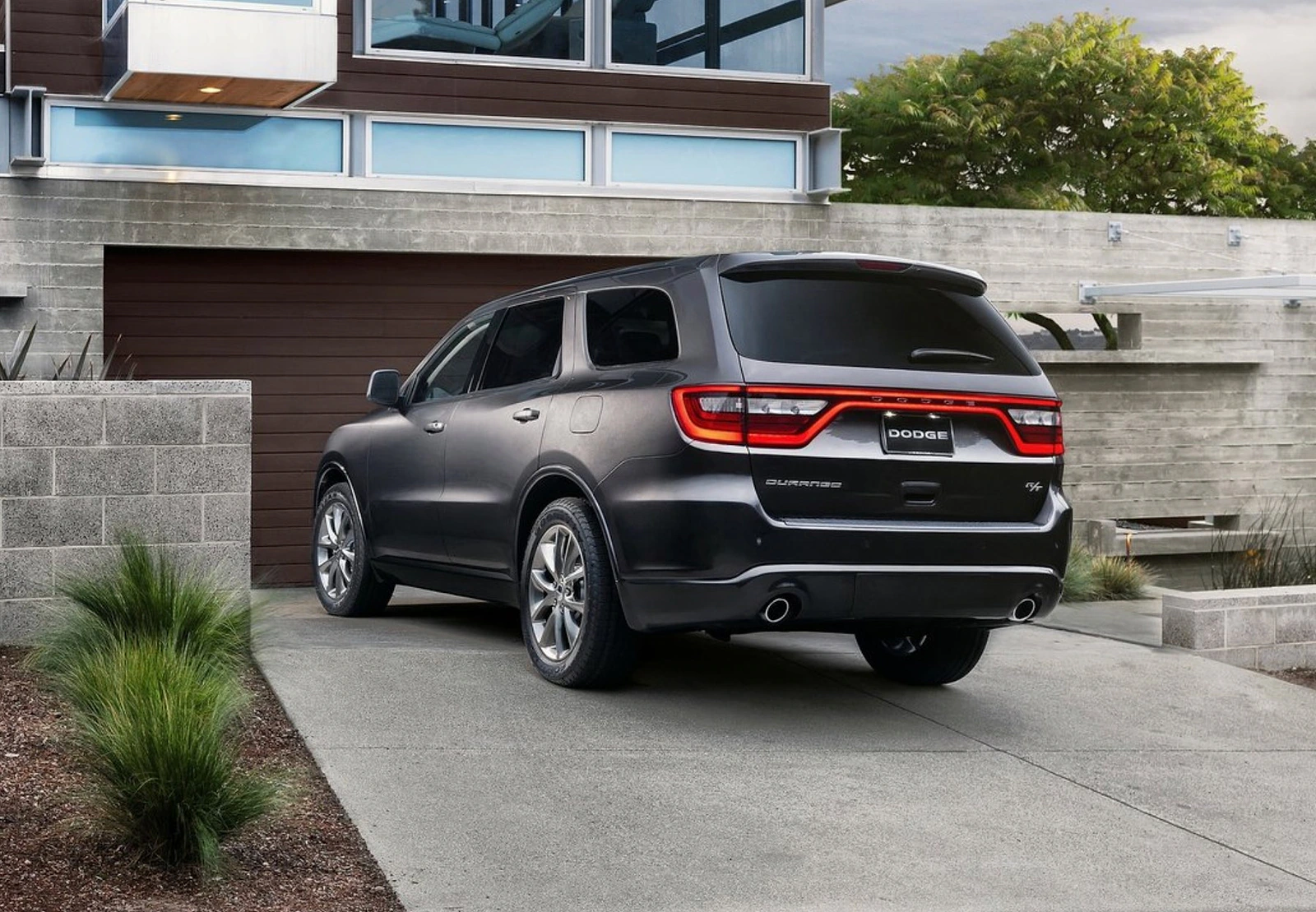 Rear three-quarter view of the 2011 Dodge Durango at a modern residence.