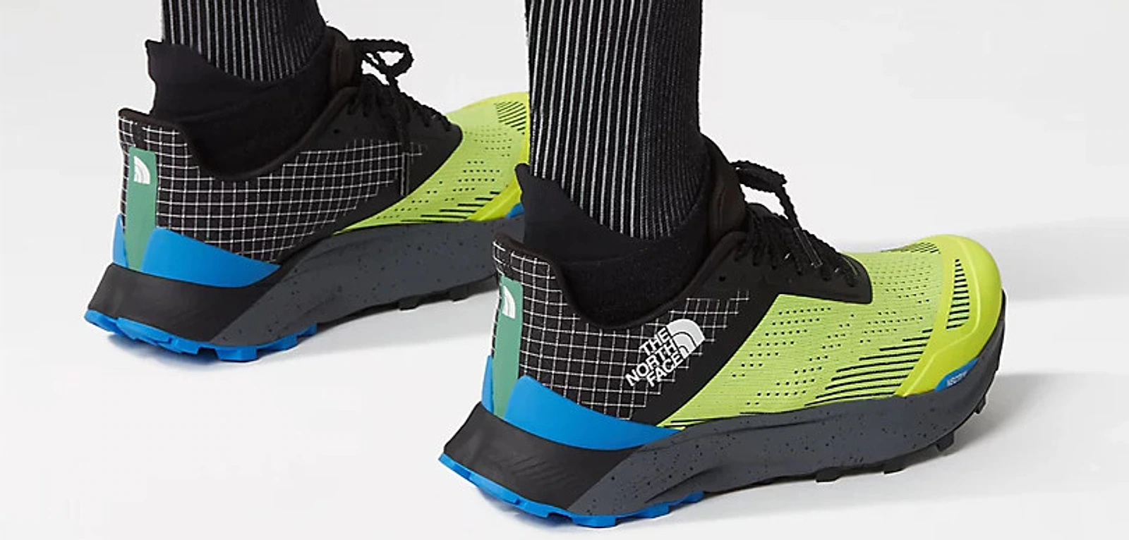The North Face performance trail shoes shown on foot from the rear.